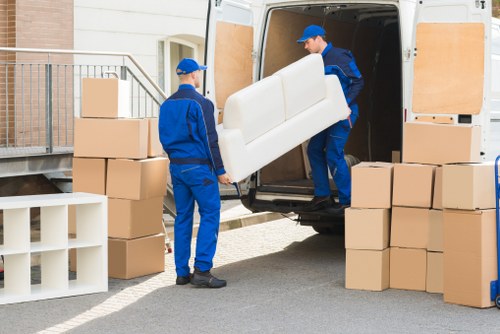Worker loading furniture safely into a van