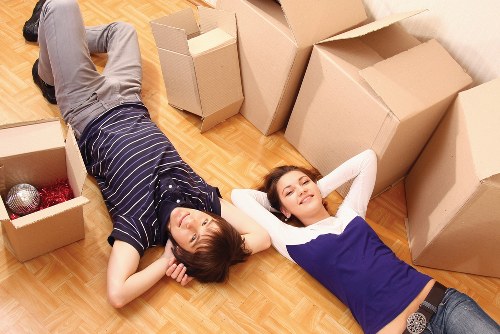 Movers transporting furniture through a residential New Addington street